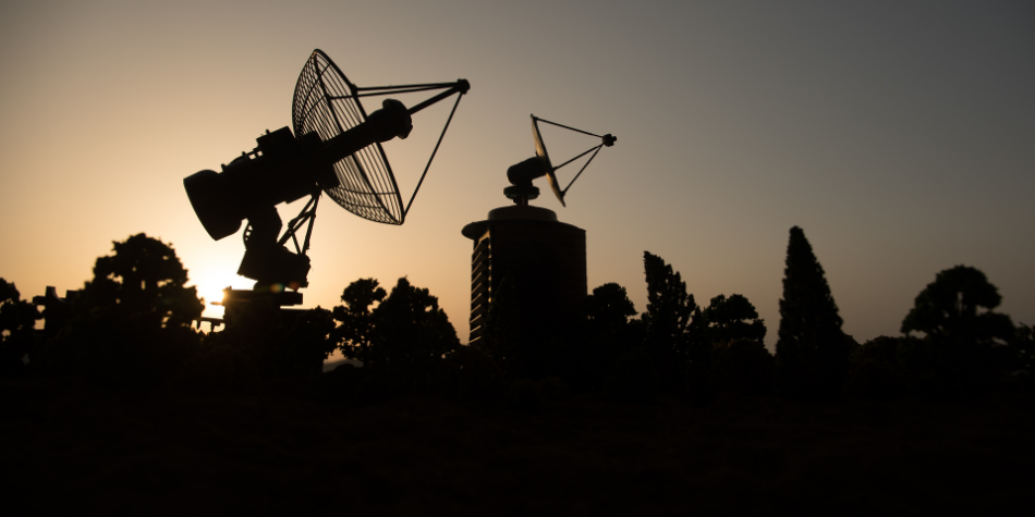 Radio antennas against the sunset at a military installation detecting and analyzing RF signals