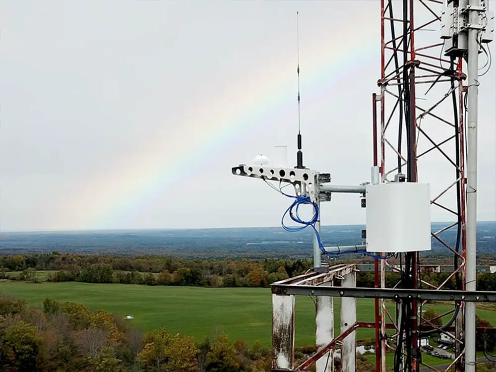 Radio frequency (RF) antannae with visible EF waves (a rainbow) in the background 