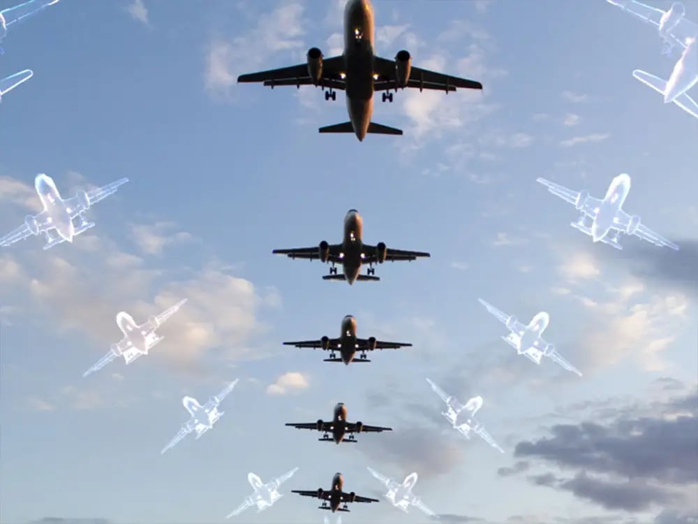 Image of one airplane with outlines of phantom airplanes alongside it demonstrating how RF spoofing can make one plane appear to be many