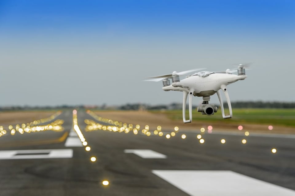 drone flying above landing strip
